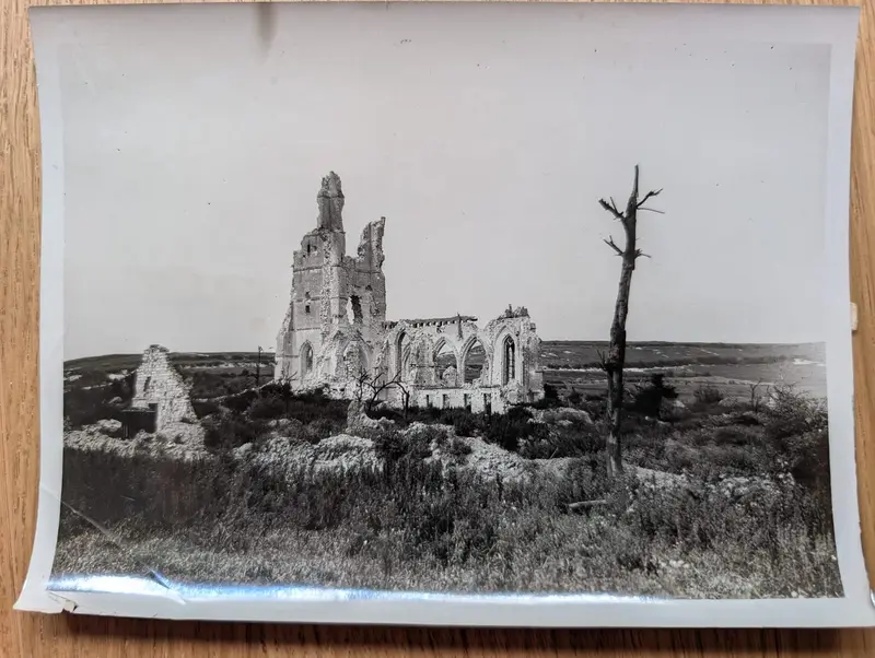 A ruined Gothic church standing in open country, a shattered tree in the foreground